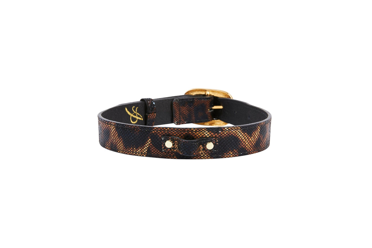 Leather collar with abstract leopard print pattern in brown and black hues, featuring vintage gold-toned Italian hardware buckle, shown on white background.