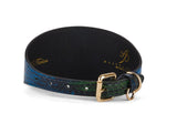 Close-up of a 3-inch wide dog collar with a glossy blue, green, and black snake pattern and gold-toned buckle and D-ring hardware.