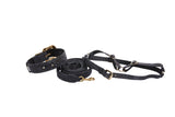 Set of black leather dog collar, leash, and harness with velvety floral patterns and gold-tone hardware, laid out on a white background.