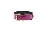 Purple patent Italian leather collar with classic gold-colored buckle and hardware, shown in a circular shape against a white background.