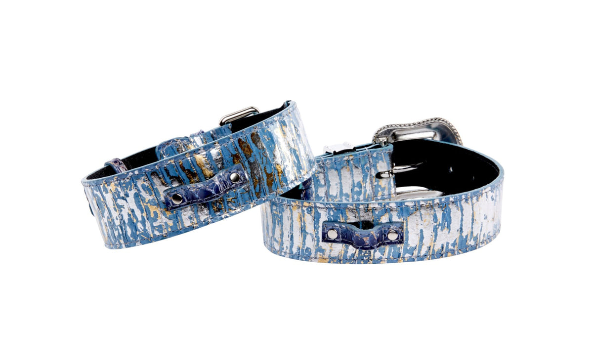 Two iridescent snake pattern collars in light and dark blue with silver accents, featuring classic buckle and Swarovski crystal buckle designs.
