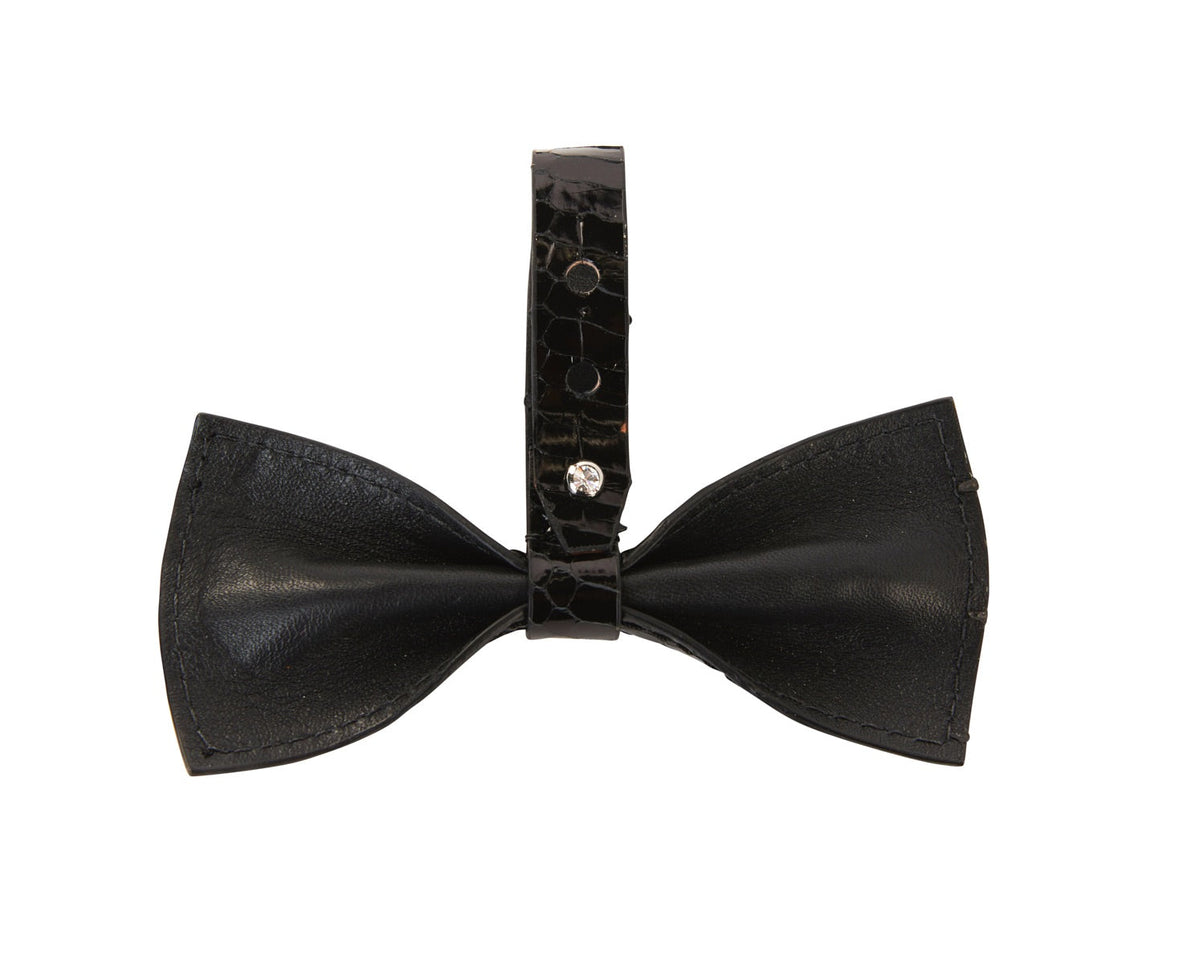 Black bowtie made of textured leather with a wide center strap featuring a silver Swarovski crystal closure.