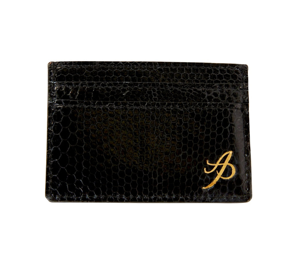 Black card wallet with textured snake skin pattern and a gold stylized 'A' logo in the lower right corner, shown from the front.