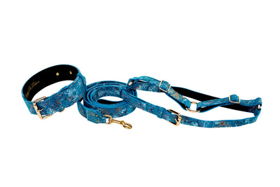 Blue Floral Mosaic Italian Leather pet collar, leash, and harness laid out on a surface