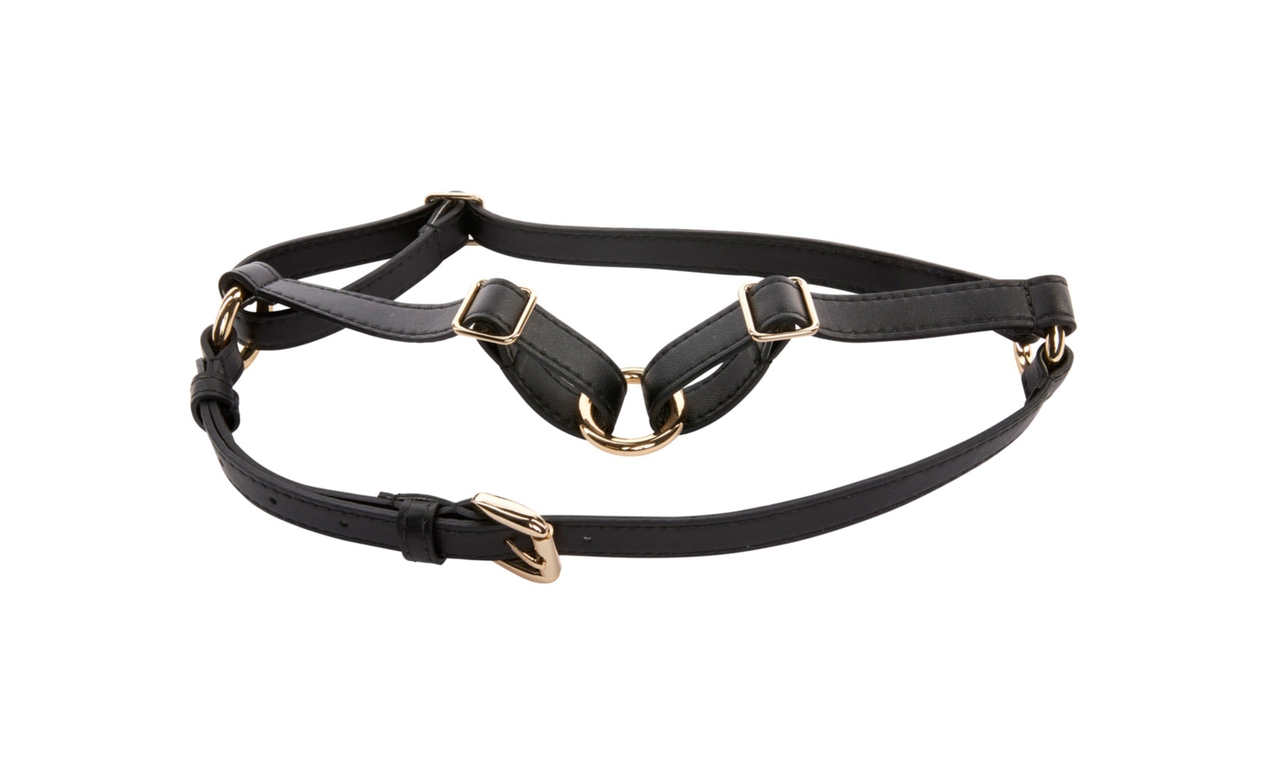 Black vegan leather harness with gold hardware displayed on a dark surface