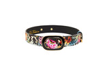 Italian leather collar with a multicolor snake print pattern and pink floral accent around a gold-edged black rectangular buckle.