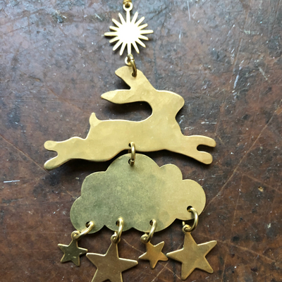 Wonderland Ornament by Vida + Luz, hand-cut hammered brass wall hanging with hanging cord