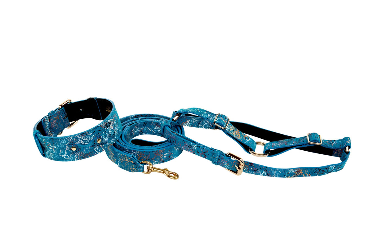 Blue floral mosaic patterned Italian leather dog collar, leash, and harness set with gold hardware on white background.