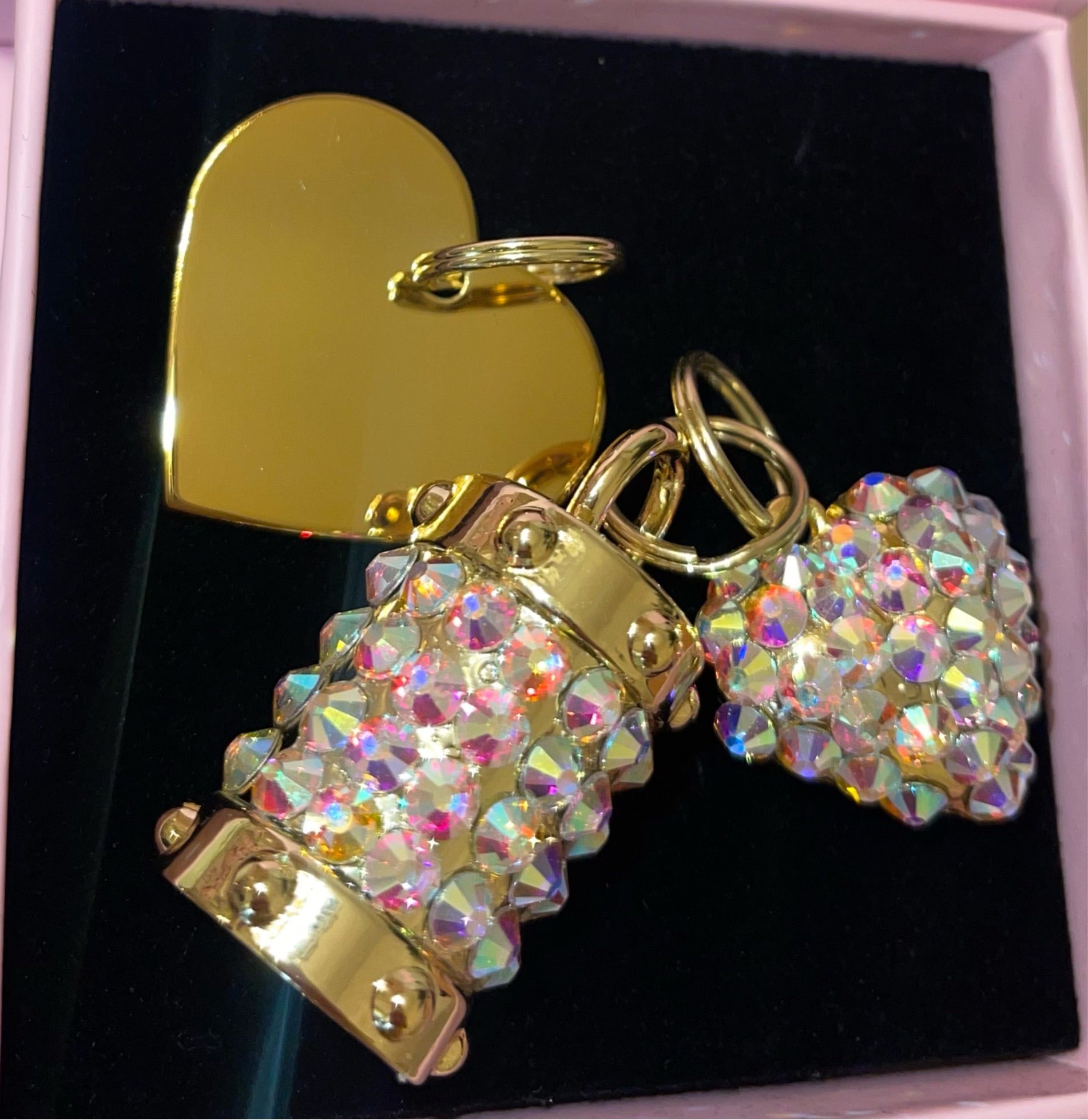 Set of three Swarovski crystal charms including engraved heart plaque, cylindrical crystal charm, and puffy heart crystal charm