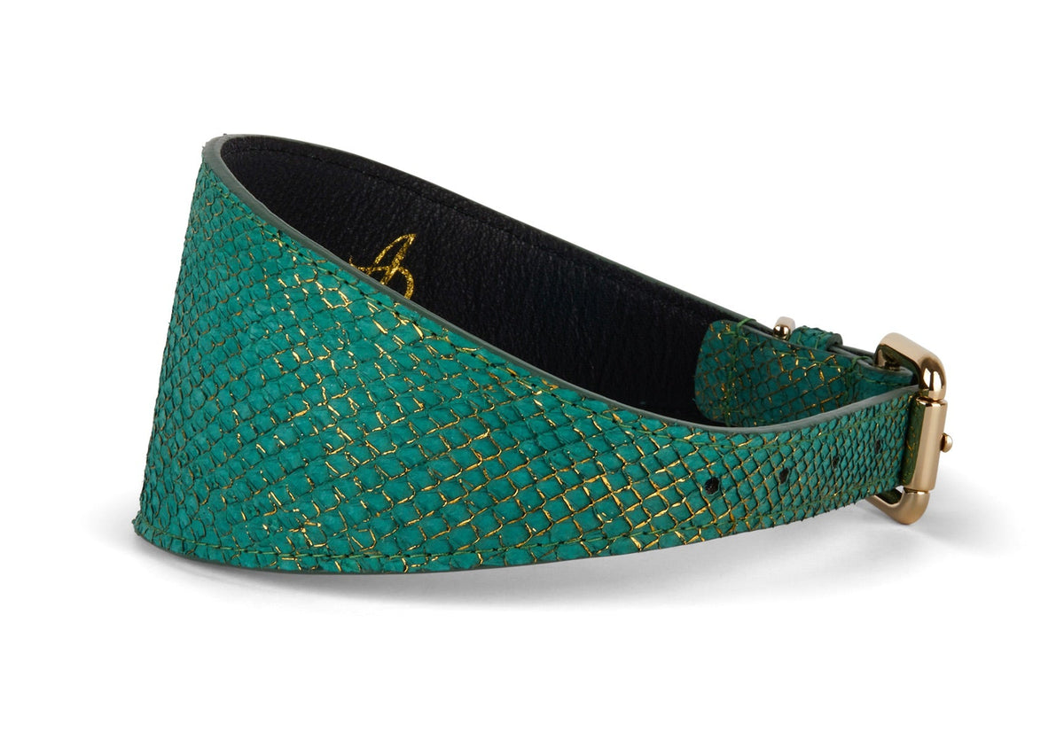 Green and gold patterned 3-inch wide style collar with a gold-tone buckle and black interior lining, shown at an angled side view on white background.