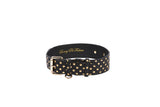 Black Italian leather pet collar with a classic buckle and gold polka dots, featuring gold hardware and the phrase Luxury Pet Fashion inside.