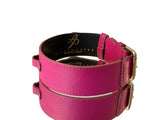 Soft fuchsia Italian leather dog collar with gold-toned classic buckle hardware and subtle embossed brand logo on the inner black lining.