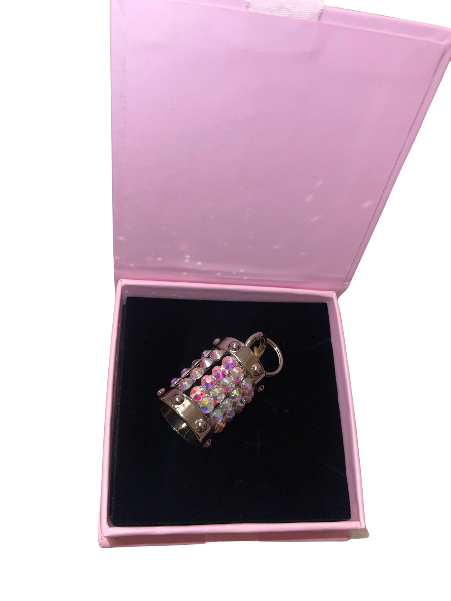 Silver cylinder charm featuring Swarovski crystals on a collar.