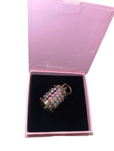 Silver cylinder charm featuring Swarovski crystals on a collar.