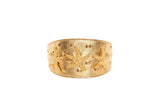 Wide gold leather bracelet featuring three embossed starfish and small pyramid studs arranged in a symmetrical pattern on its surface.
