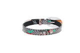Leather collar embossed with black and gray snake print, featuring painted pansy flowers in orange and green with a silver D-ring buckle, shown flat on white background.