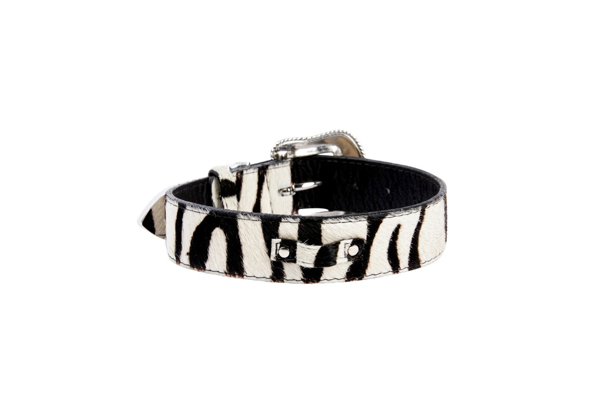 Black and white zebra print leather bracelet with hair-on-hide texture and polished silver-tone buckle and hardware details.