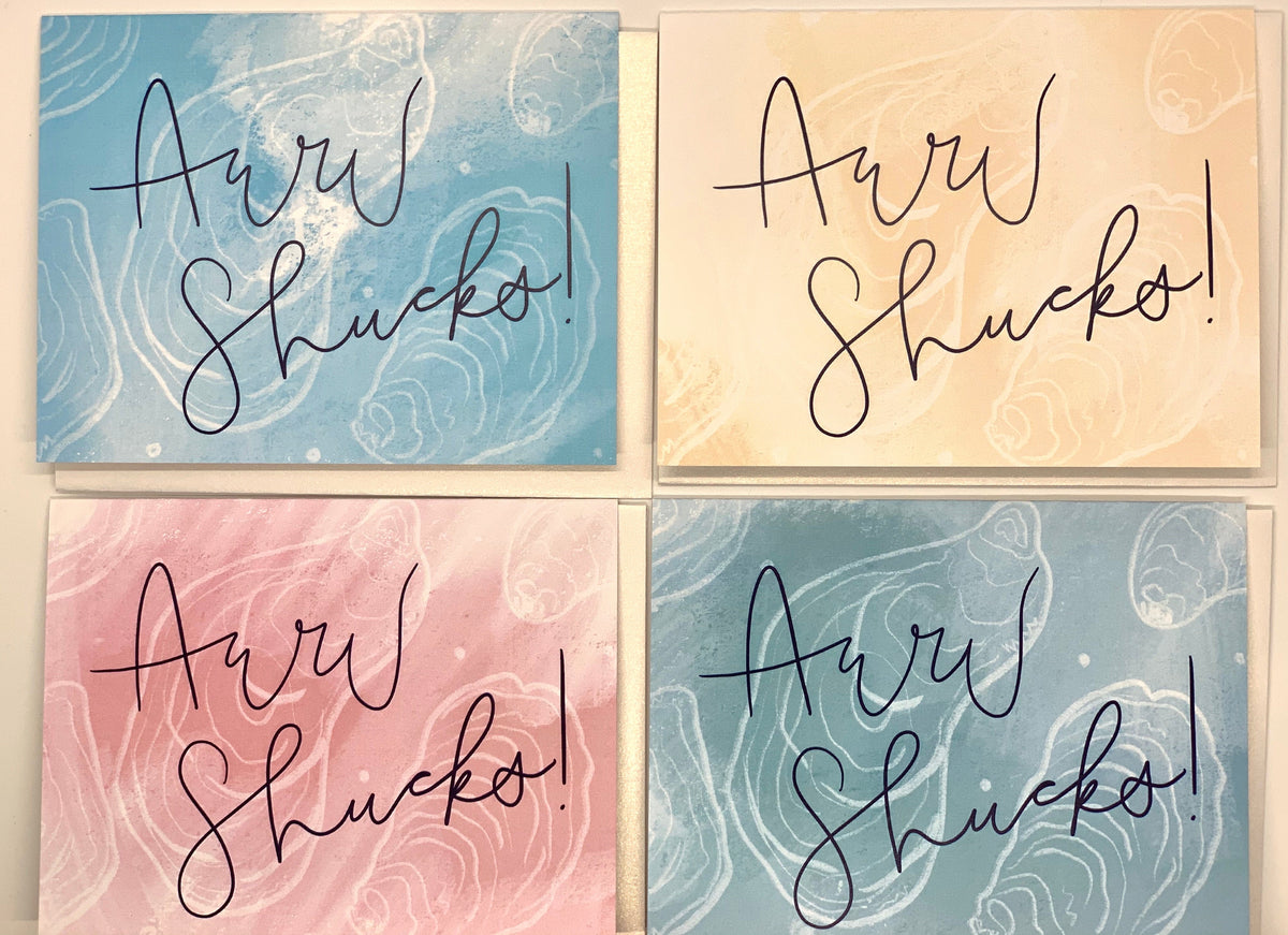 Four cards with swirled pastel backgrounds in light blue, cream, pink, and gray, each featuring handwritten-style text 'Aww Shucks!' in black ink.