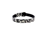 Black and white snake-patterned collar with silver oval buckle and hardware, shown in a circular shape against a white background.