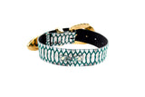 Green and off-white embossed python print leather belt with gold-tone ornate metal buckle and tip, shown coiled on white background.