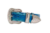 Bright blue snake skin belt with curved buckle, loop, and tip adorned with small, sparkling silver Swarovski crystals against a white background.