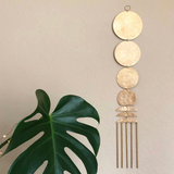 Here Comes the Sun brass wall hanging by Vida + Luz on a neutral wall