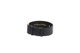 Wide black leather collar with gold buckle and two small gold rivets, featuring subtle embossed text inside the band.