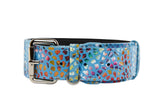Blue leather dog collar with colorful mosaic floral pattern and silver buckle and D-ring hardware, shown against a white background.