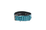Turquoise embossed croc leather dog collar featuring silver classic buckle hardware and multiple adjustment holes, with a black inner lining.