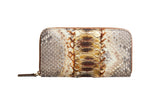Neutral brown and gold zippered wallet with embossed snakeskin texture and a central gold-toned scale pattern, shown front-facing against a white background.