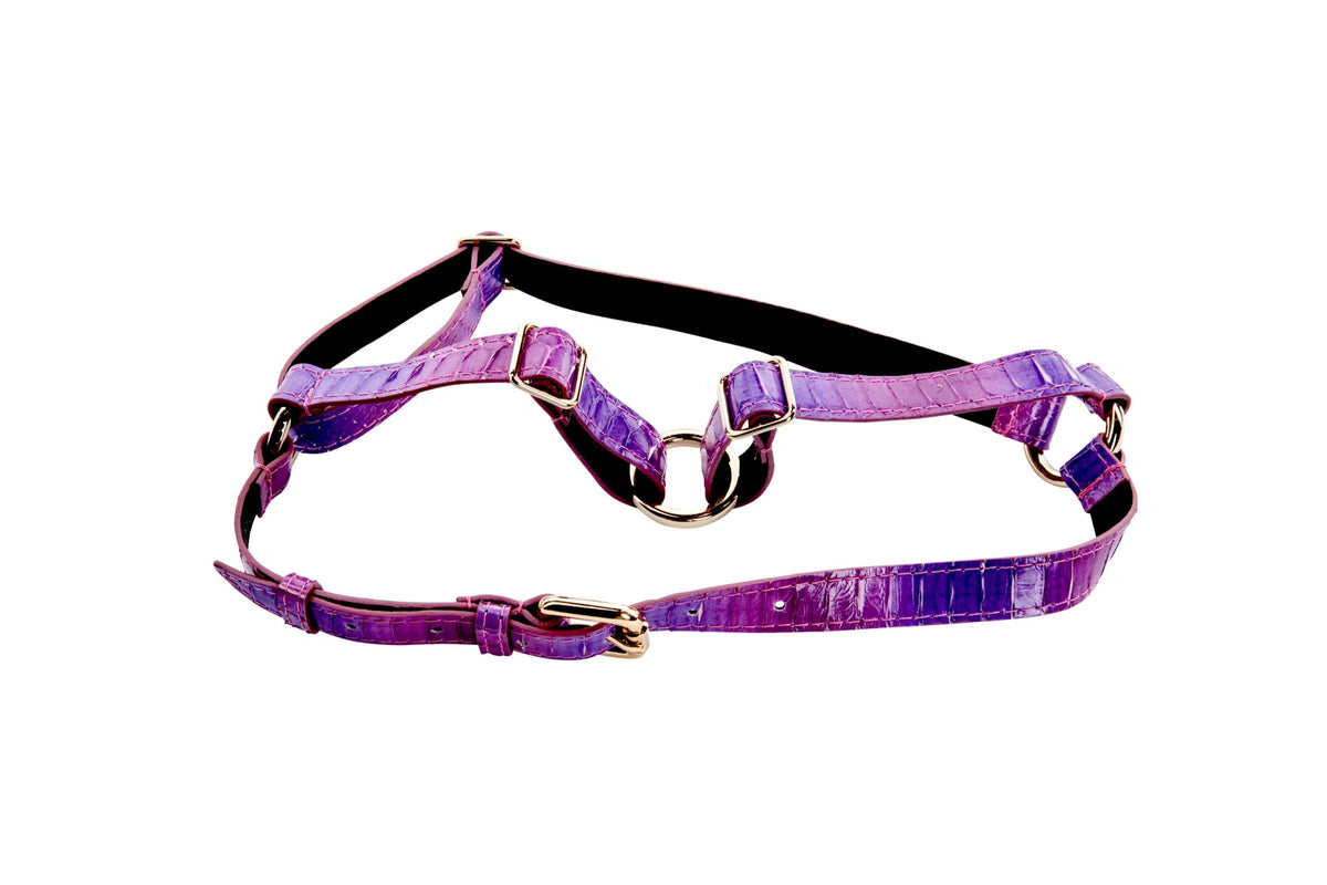 Two-tone purple snake-patterned leather harness with gold-tone buckles and adjustable straps, displayed against a white background.