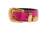 Fuchsia pebbled Italian leather belt with ornate gold Western-style buckle and matching gold floral-engraved keeper and tip, shown coiled on white background.