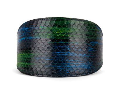Blue, green, black, and yellow snake patterned 4 inch wide collar with gold hardware laid on a neutral surface
