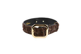 Brown leather bracelet with a snake print texture and a polished gold-tone rectangular buckle, shown against a white background.