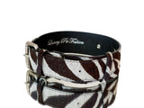Collar with zebra print hair-on-hide leather strap featuring classic silver buckle and loop, embossed with 'Luxury Pet Fashion' on black inner lining.