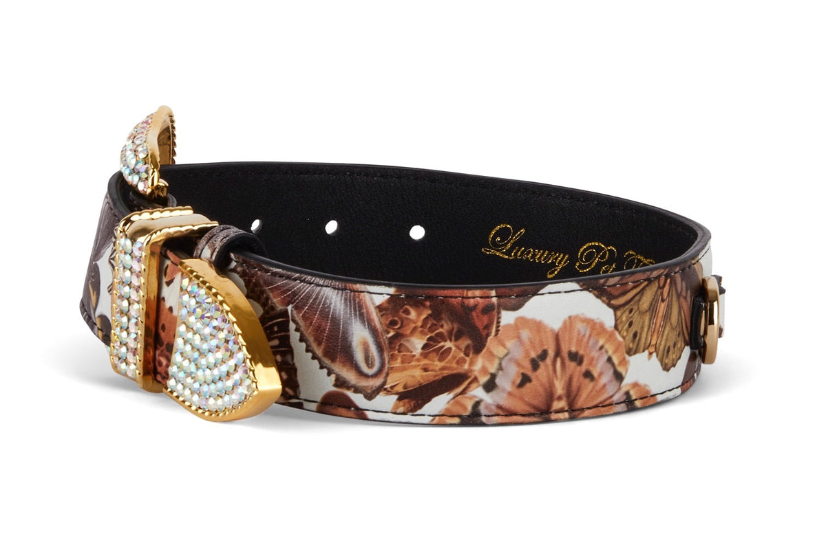 Leather collar with detailed butterfly print in brown and beige tones, featuring gold-tone hardware embellished with sparkling Swarovski crystals.