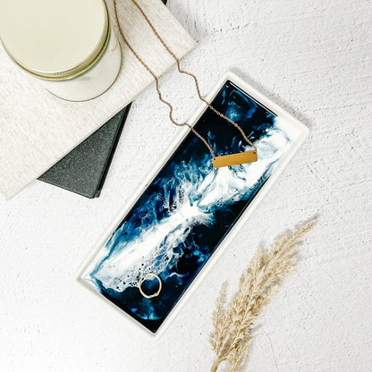 Necklace displayed on a blue and white Small Ceramic Resin Tray with a candle and pampas grass.