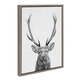 Black and white close-up of a red deer with large antlers on textured canvas, framed in a simple light brown wooden frame, shown at a slight angle.