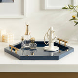Glossy navy blue hexagonal decorative tray with brass handles holding perfume bottles and a white jewelry stand with pearl necklaces.