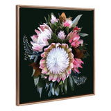 Framed canvas painting of a wild flower bouquet with large white and pink petals, surrounded by green and brown leaves, set against a dark background.