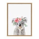 Portrait of a gray koala with fluffy ears wearing a pink floral crown, centered on a white background in a light wooden frame.