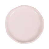 Round pale pink tray with softly irregular edges and a smooth, glossy surface, shown from above on a white background.