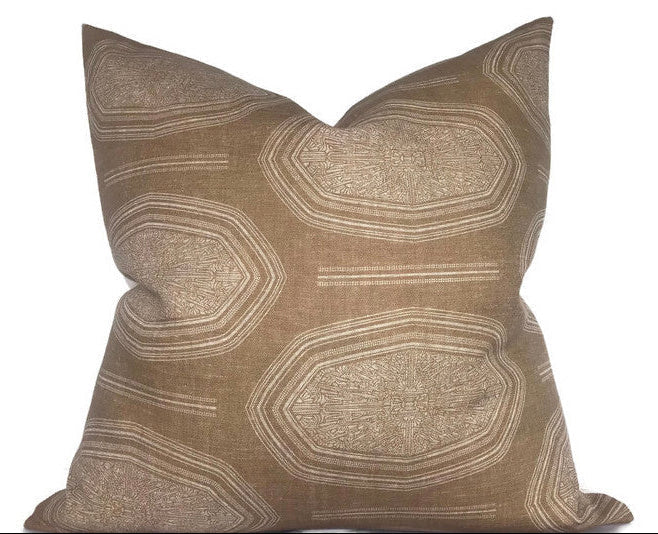Kamba Pillow Cover in Sand laying on sofa with luxurious linen texture