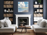 Contemporary living room with navy blue walls, white fireplace, symmetrical beige sofas, and a framed seascape painting above the mantel.