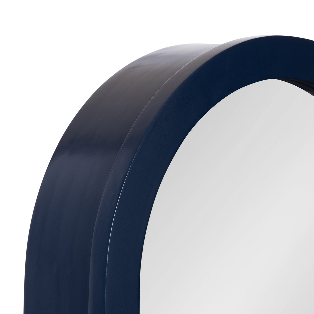Close-up of a large arch-shaped mirror with a smooth, thick navy blue frame, showing a sleek, rounded edge and glossy finish.