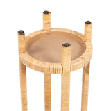 Underside view of a round wooden table with four cylindrical legs wrapped in light-toned layered wicker or rattan, showing black rubber feet and visible screws attaching the legs.
