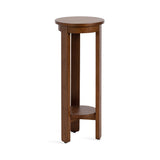 Tall round side table with slender legs and a small round shelf near the base, featuring warm brown wood with smooth finish.