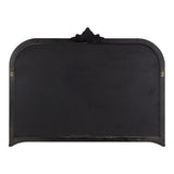 Arched rectangular black metal wall mirror with decorative crest detail at the top center and small hanging hooks on each side.