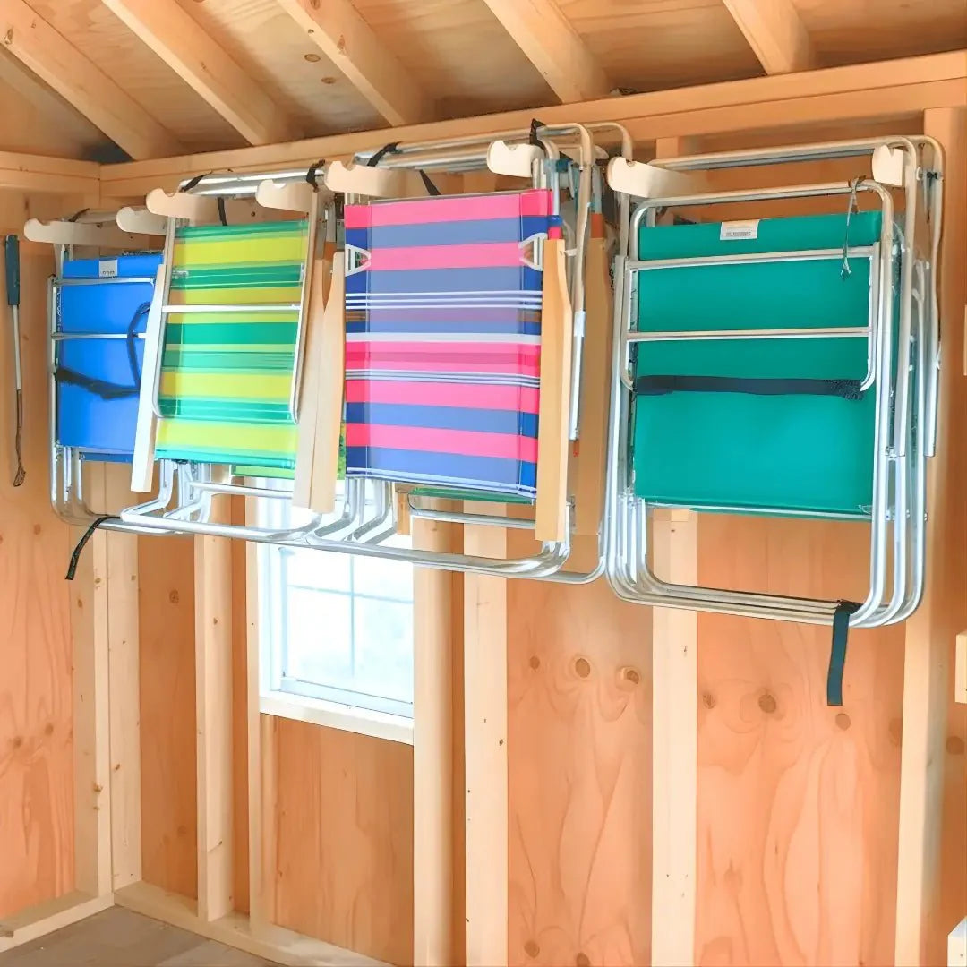 Lawn Chair Organizing Stud Mounted Hooks mounted on a garage wall holding stacked lawn chairs