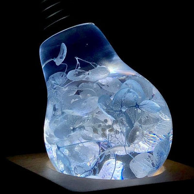 Three handcrafted flower-shaped resin LED bulbs in a 3-pack